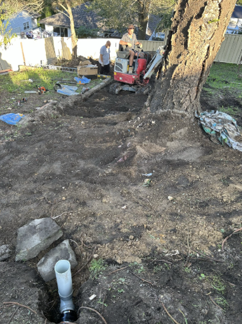 Old sewer pipe exposed in trench