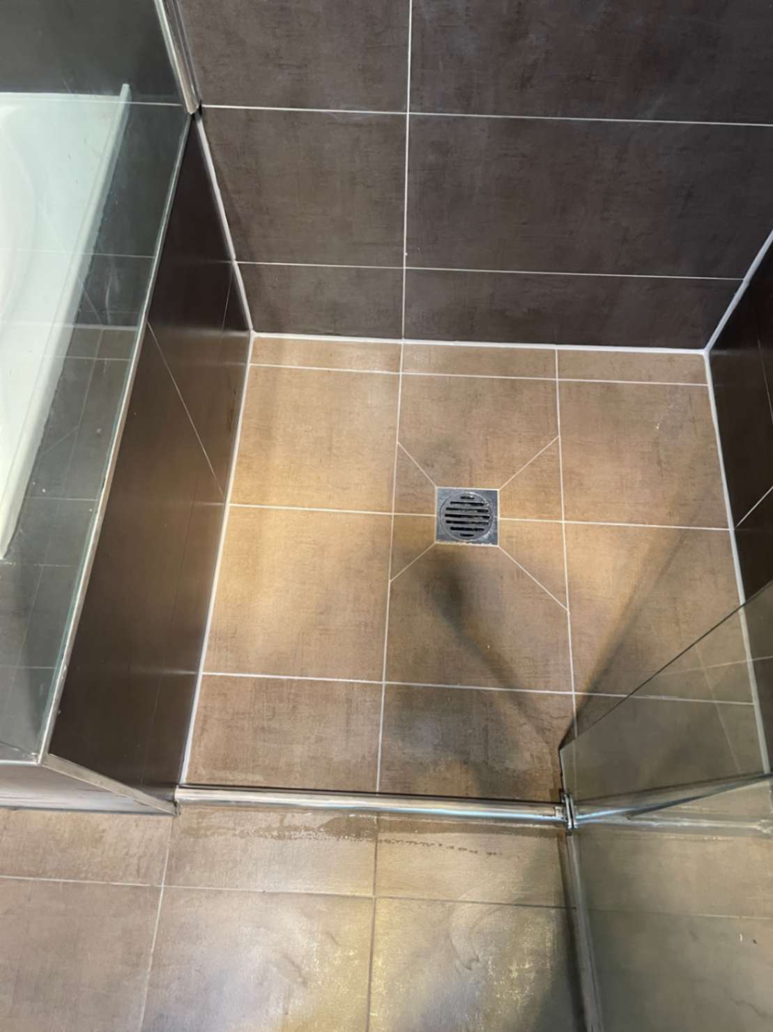 Shower recess with central floor drain.