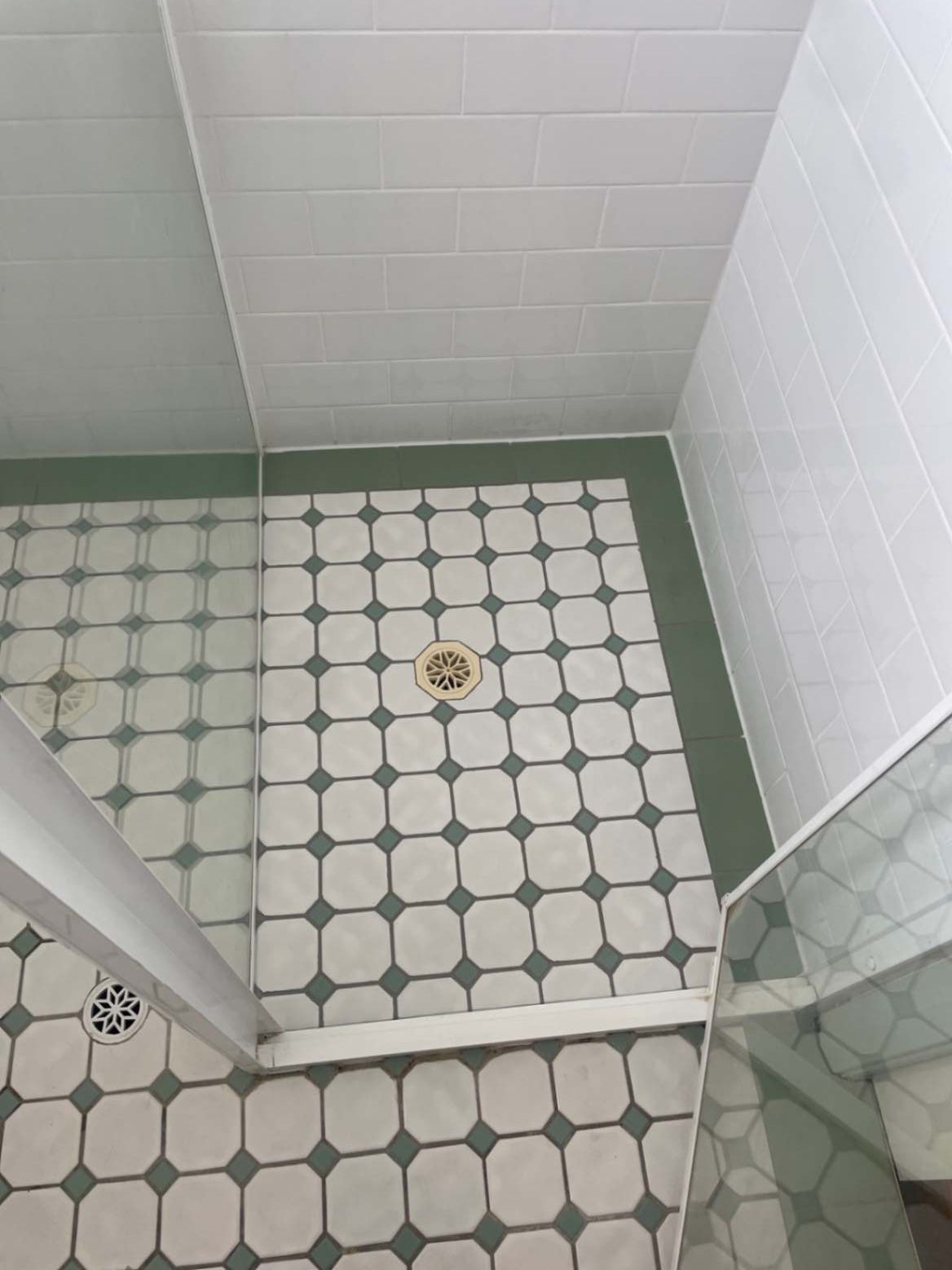 Shower floor with octagonal tiles and drain.