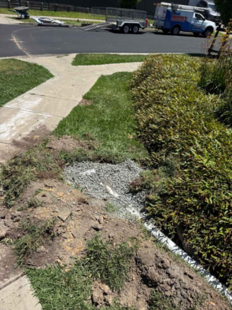 Front yard with damaged lawn area.