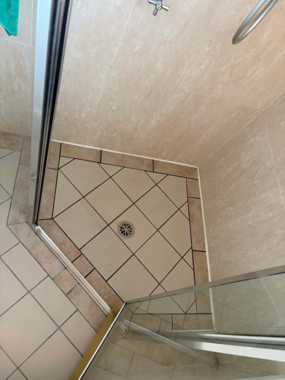 Shower base showing drain area before repair