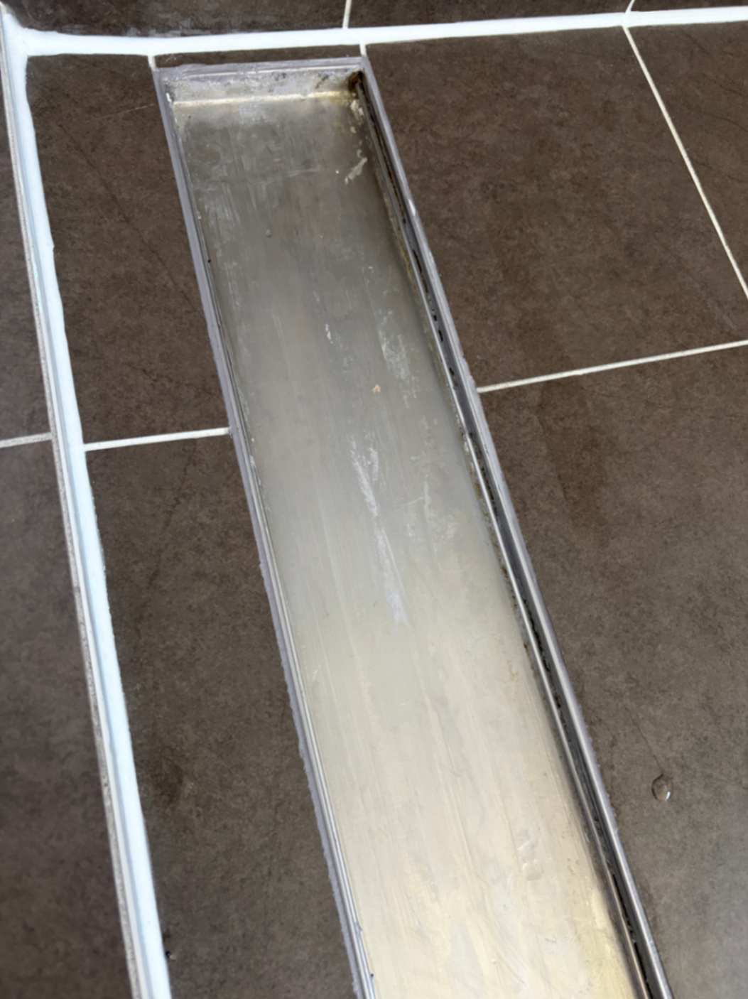 Moisture visible near shower edges before restoration
