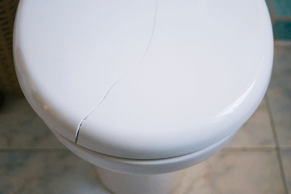 Hairline crack across the ceramic of a toilet pan requiring full replacement